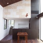 黒い天然木が張られたカウンターに仕切られたキッチン